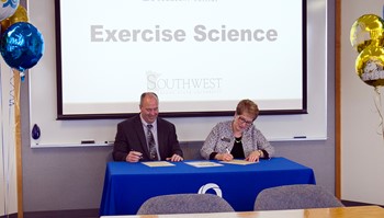 President Hanson signing agreement for exercise science bachelor degree with Southwest Minnesota State University President Gores