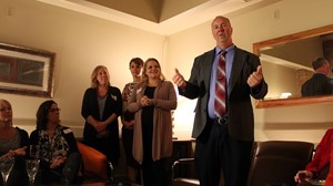 Nucleus Clinic Open House attendees listen to Anoka-Ramsey Community College President Kent Hanson speak about the importance of the college’s new partnership with the clinic.