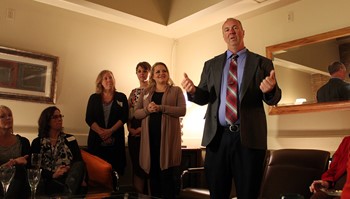 Nucleus Clinic Open House attendees listen to Anoka-Ramsey Community College President Kent Hanson speak about the importance of the college’s new partnership with the clinic.
