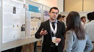 An Anoka-Ramsey Community College student discusses his undergraduate research as part of the college’s Outstanding Scholarship, Creative Activities and Research Symposium (OSCARS).