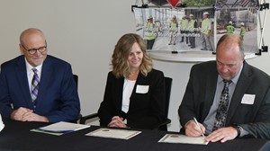 (from left) Al Gerhardt, Kraus-Anderson Construction Company Chief Operating Officer and President, Jodie Greising, Director of MJSP and Kent Hanson, Anoka-Ramsey Community College President, sign a $394,279 Minnesota Job Skills Partnership (MJSP) grant that will allow the college to provide customized training and development to 500 employees at Kraus-Anderson. 